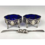 A pair of Georgian reticulated silver salts with cobalt blue glass liners, each having swagged and