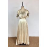 A Belle Epoch lady's champagne silk evening dress retailed by Frederick Gorringe Ltd of Buckingham
