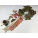 A German Third Reich funeral wreath, paper flag pins etc