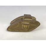 A small cast brass model of a Great War tank, advertising McKenzie Brothers Ltd "Tank" brand metal