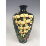 A Moorcroft "Wisteria" pattern shouldered vase designed by Philip Gibson, impressed and painted