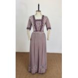 An Edwardian lady's mauve crepe tea dress retailed by Paxton and Purves of Berwick on Tweed, of