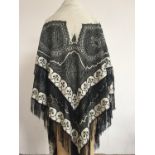 A Victorian embroidered cream wool shawl, having black chain-stitched boteh decoration, applied in