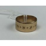 A 9ct gold wedding band, the broad face decorated with a band of bright-cut stars, 6.8g