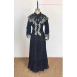 A late Victorian lady's black wool crepe polka-dot day dress, of two-piece construction, the boned