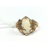 A 9ct gold and shell cameo dress ring, having the carved profile of a young lady, claw-set within