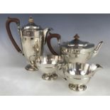 A George V silver four-piece tea set, comprising tea pot, hot water jug, sugar bowl and milk jug,