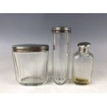 A Victorian silver mounted and cut-glass toiletry jars, having engine-turned covers and an