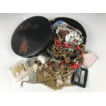 A Japanned collar box containing a quantity of vintage costume jewellery, including necklaces,
