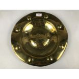 An Arts and Crafts style raised and planished brass dish, 36.5 cm