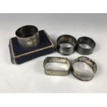 Sundry silver napkin rings having foliate engraved / engine turned decoration, 90g total