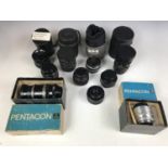 A Primotar E 1:3.5/50 camera lens together with a Pentacon 2.8/135 lens, a Tessa 2.8/50 Carl Zeiss