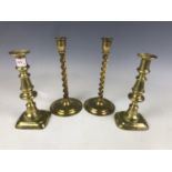 Two pairs of brass candlesticks, 25 cm and 22 cm respectively