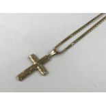 A 9ct gold cruciform pendant on chain, 5.7g total
