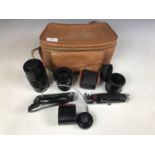 A case of camera lenses including a Photax Paragon 1:3.5 F=200mm lens, a Kenlock 49.0mm Skylight -