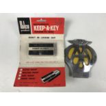 An AA bumper badge together with a 1970s Polco "Keep-a-Key" motorist's magnetic spare key box