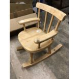 A child's pine rocking chair