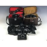 A cased Zenit II camera and two lenses with a light meter together with a cased Zenit 12xp with IS