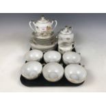 An oriental eggshell porcelain tea service for six, having lithophane bases depicting a geisha