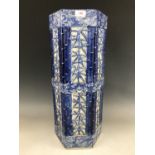 An oriental porcelain stick stand, having moulded and painted blue and white decoration in depiction