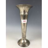 A George V silver trumpet-form vase, loaded, 25 cm high