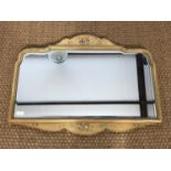 A vintage bevel-edged wall mirror having a shaped and hand-painted frame, 62 x 82 cm