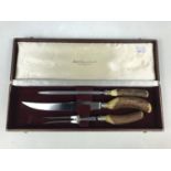 A vintage antler-handled cased carving set