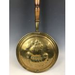 A Victorian brass bed warming pan with embossed sailing vessel