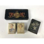 A city of Carlisle royal commemorative coronation tin, together with two matchbox covers and one
