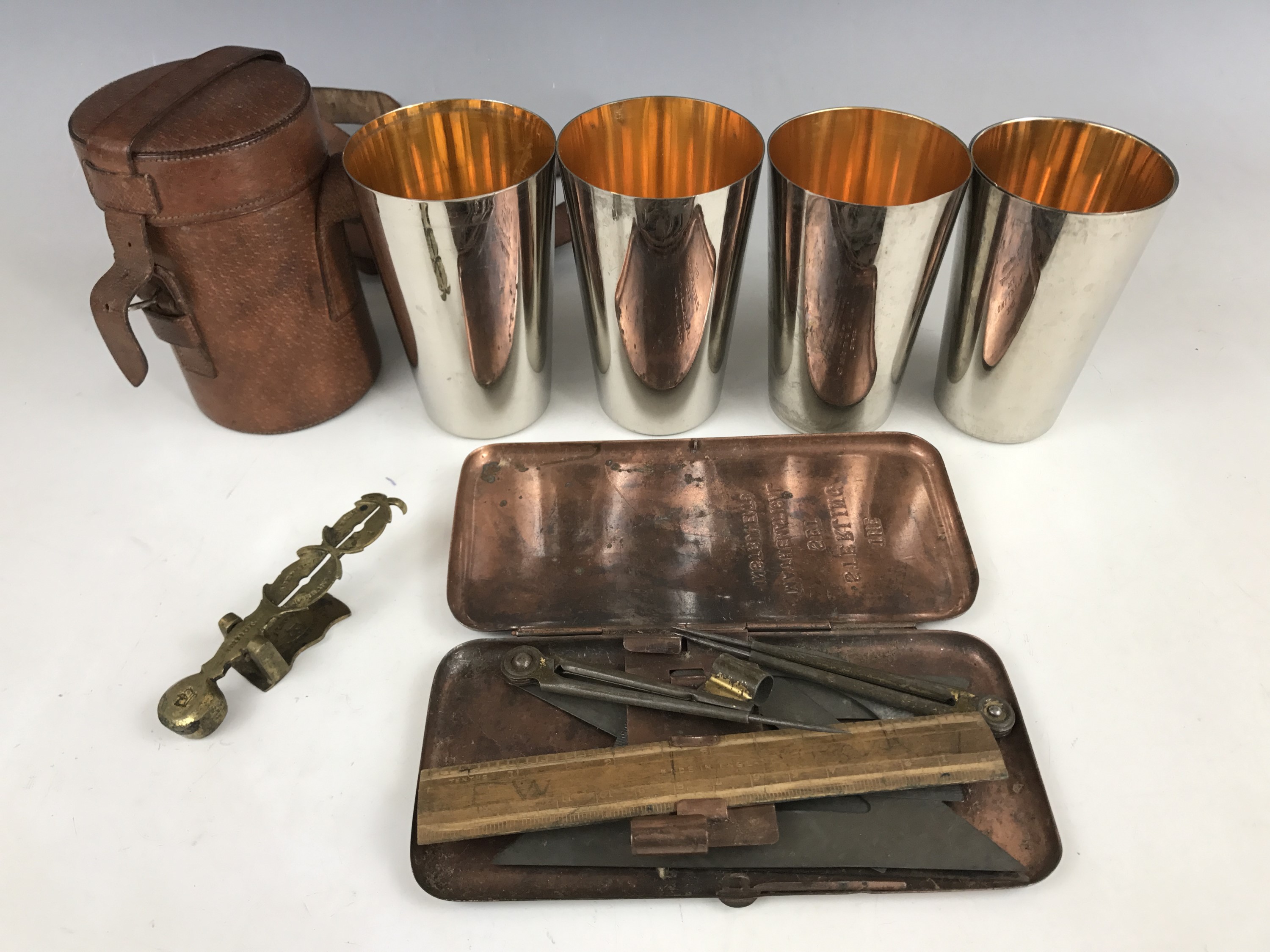 A vintage leather-cased set of four electroplate nesting / stacking beakers, together with a "