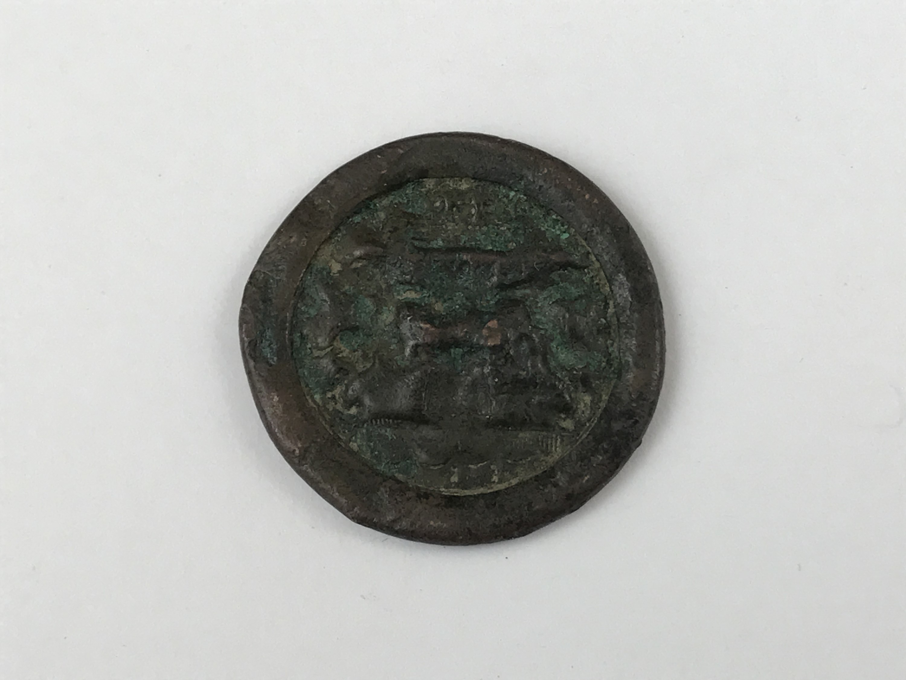 A copper livery button, 17th / 18th Century