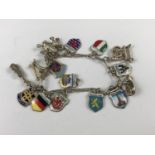 A white-metal charm bracelet with continental souvenir charms, 26.2g