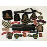A quantity of military cloth insignia
