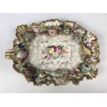 A porcelain dish, hand enamelled and shell-encrusted, second quarter 19th Century, (a/f)