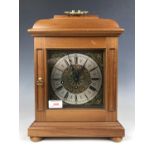 A mahogany mantel clock retailed by J J E England