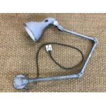 An industrial wall mounted angle poise lamp