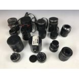 A Hoya 1:2.8 F=28mm camera lens together with a Ricoh 1:2 50mm lens, a Mamiya Sekor 1:2 F=50mm lens,