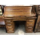 A late 19th Century oak roll-top desk, 122 x 67 x 112 cm