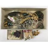 A quantity of vintage costume jewellery, including paste brooches, clip-on earrings and faux pearls