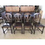 Four 1930s hide upholstered dining chairs with Art Deco style "rising sun" back splats