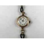 An early 20th Century lady's 9ct gold cased wristlet watch, having a Swiss made movement, white