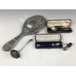 Sundry silver, including a late 19th Century white-metal hand mirror, a silver souvenir spoon, one