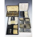 A cased set of twelve electroplate teaspoons with sugar tongs, together with fish eaters and