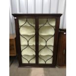 A fine George III mahogany hanging corner cabinet with curvilinear astragal glazed doors