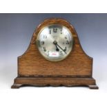 An oak cased mantel clock by Gilbert & Co of Connecticut, retailed by Johnson Ltd