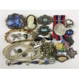 A quantity of vintage costume jewellery and a Second World War medal