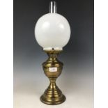 An early 20th Century Samuel Heath and Sons brass oil lamp with duplex burner, glass funnel and