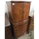 A reproduction walnut bow-fronted cabinet on chest of diminutive stature, 63 x 40 x 130 cm