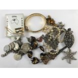 A quantity of costume jewellery including a heart-shaped gold-stone pendant and a coin bracelet