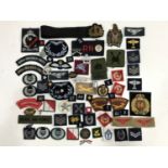 A quantity of British military cloth and metal insignia etc